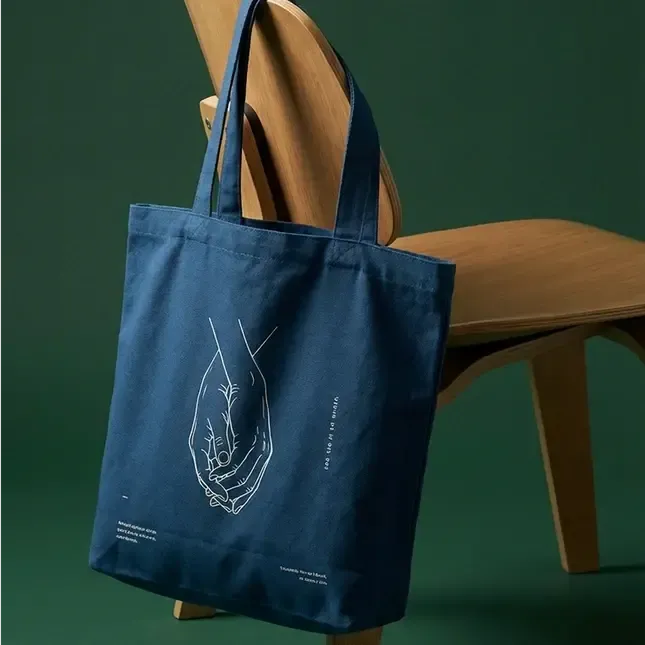 A printed denim tote on a wooden chair