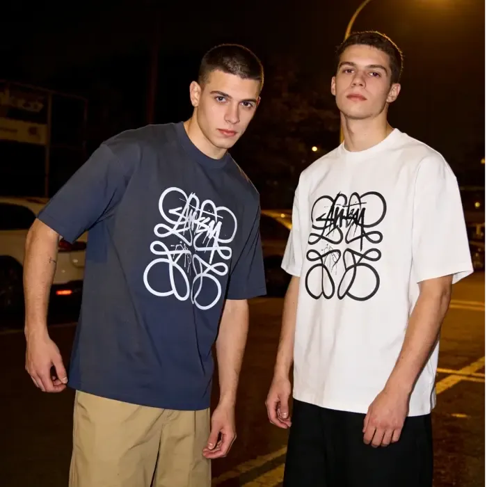 Two models wearing printed shirts
